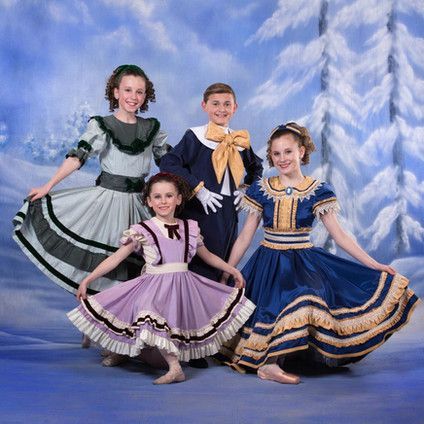 A group of children are posing for a picture in their costumes.