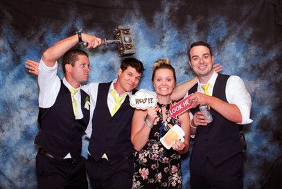 A group of people are posing for a picture in a photo booth.