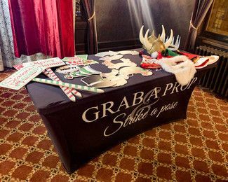 A photo booth with a table cloth that says grab a photo