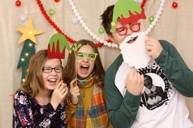 A group of children are posing for a picture in a photo booth.