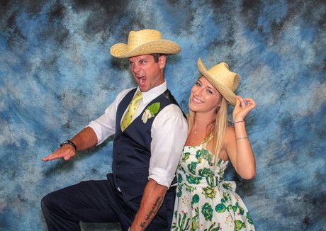 A man and a woman wearing cowboy hats are posing for a picture.