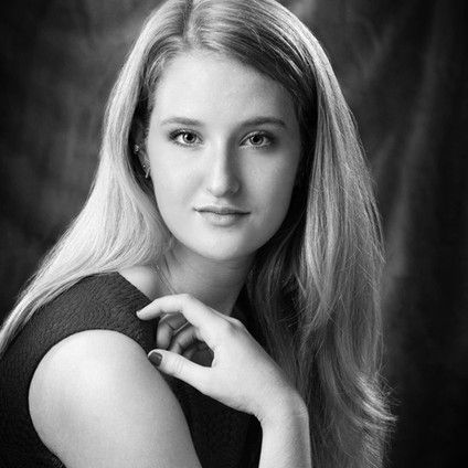 A black and white photo of a young woman with long blonde hair.