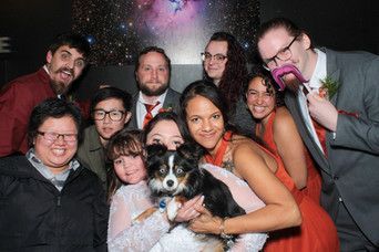 A group of people are posing for a picture with a dog.