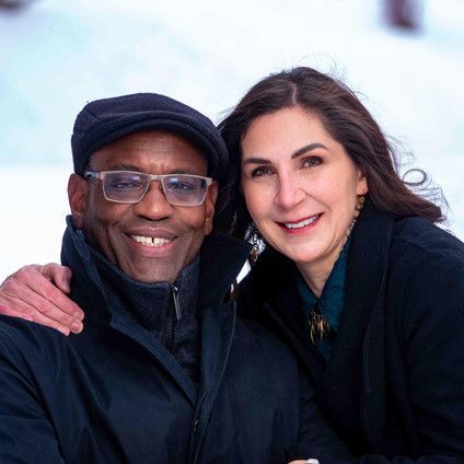 A man and a woman are posing for a picture in the snow.