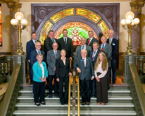 A group of people are posing for a picture on the steps of a building.