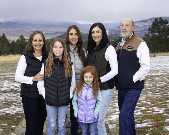 A group of people are posing for a picture in a field.
