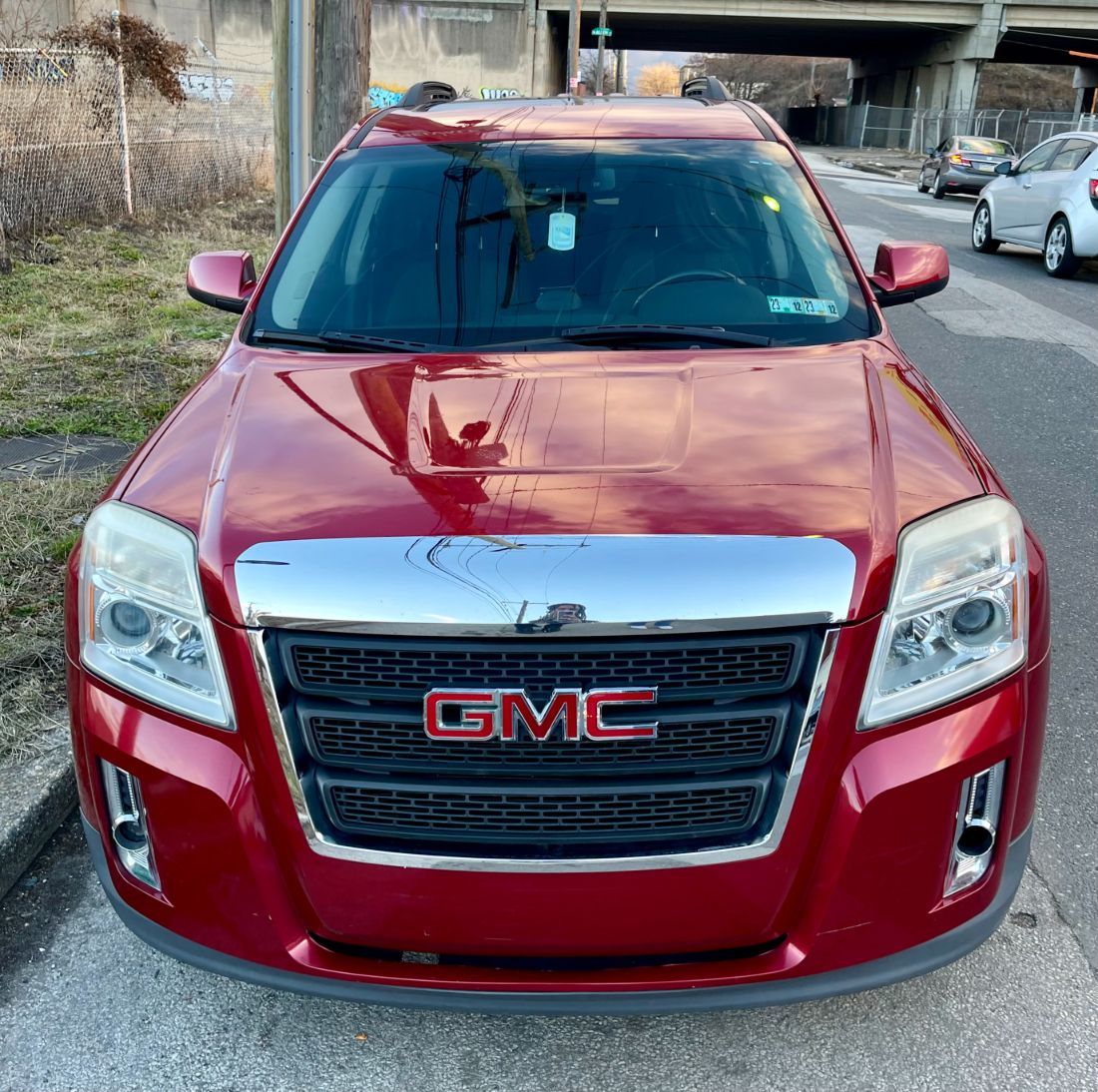 Dirty car interior with spotted seat covers, bottles, and grime. We brought the water and power and she is very happy.