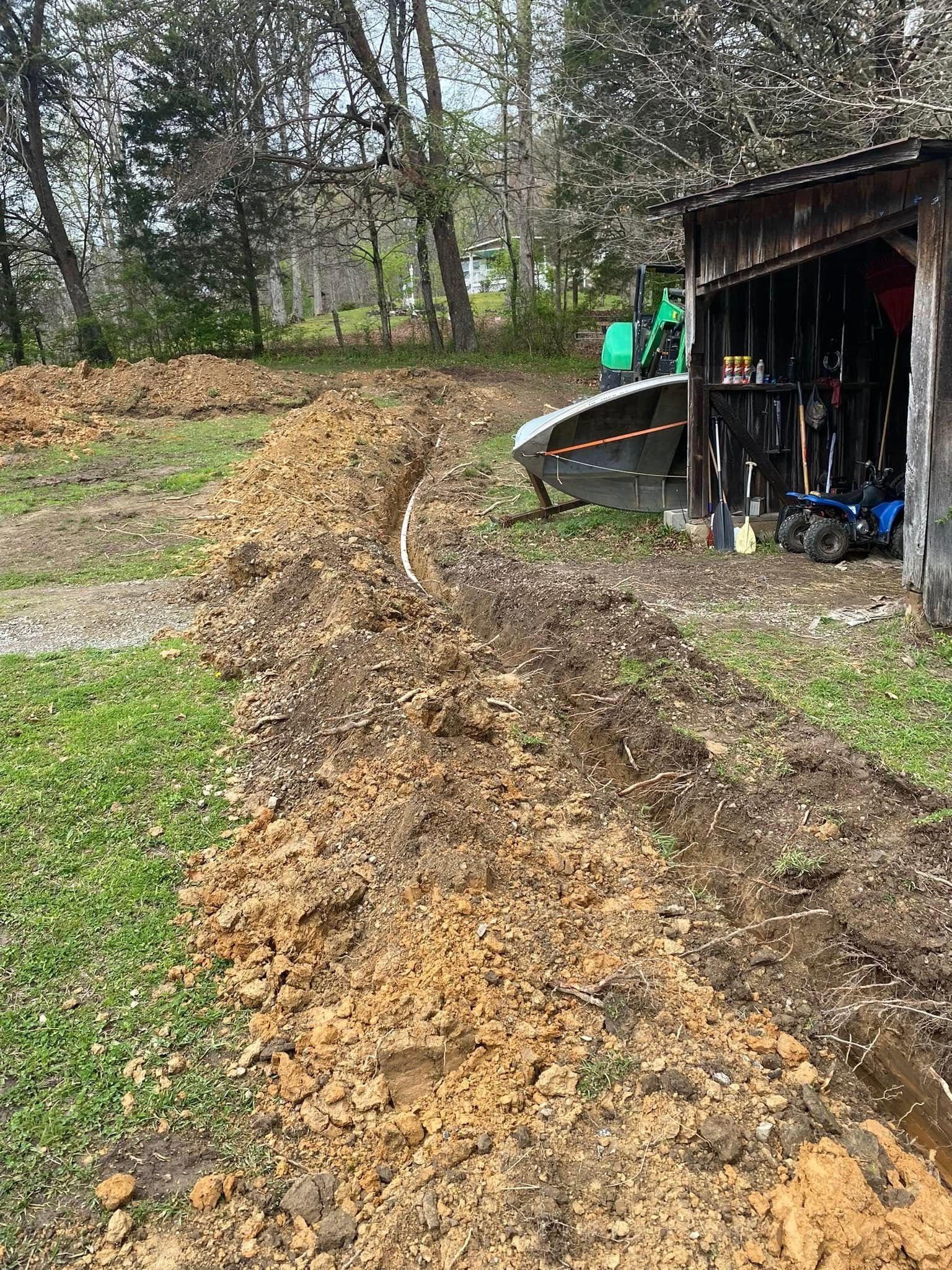 A pile of dirt is sitting next to a shed in a yard.