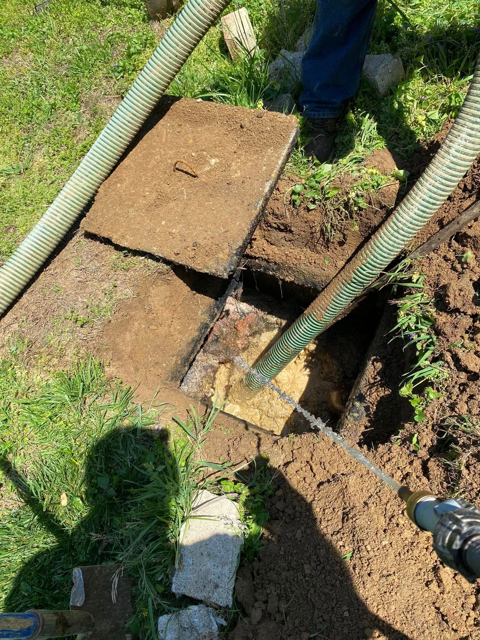 A person is pumping dirt into a hole in the ground.