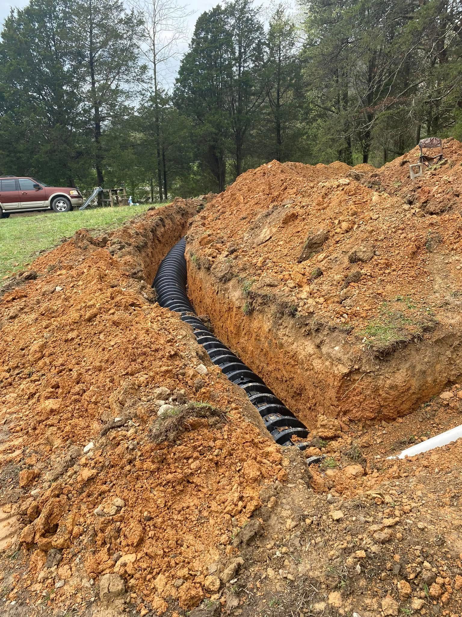 A large pile of dirt is sitting in the middle of a dirt field.