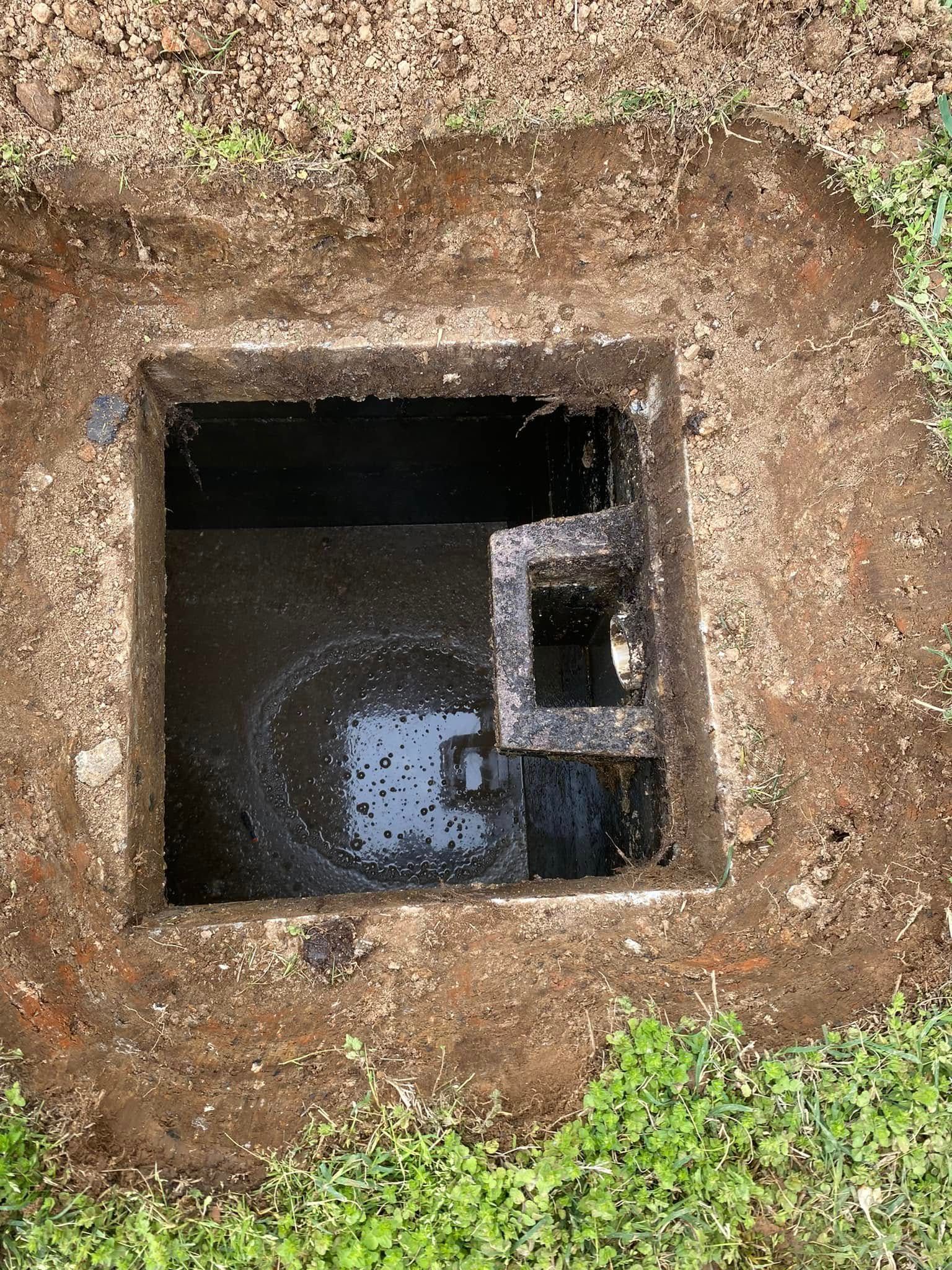 A hole in the ground with water coming out of it.