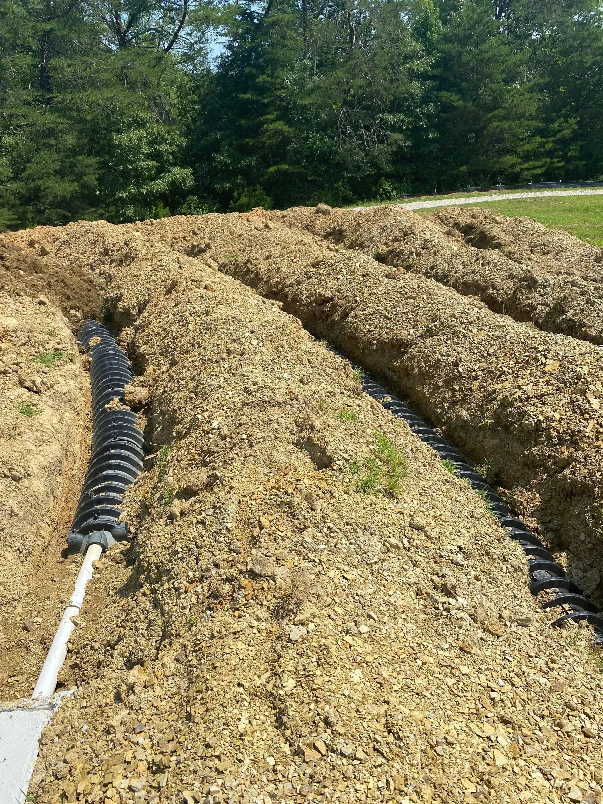 A large pile of dirt with a pipe in the middle of it.
