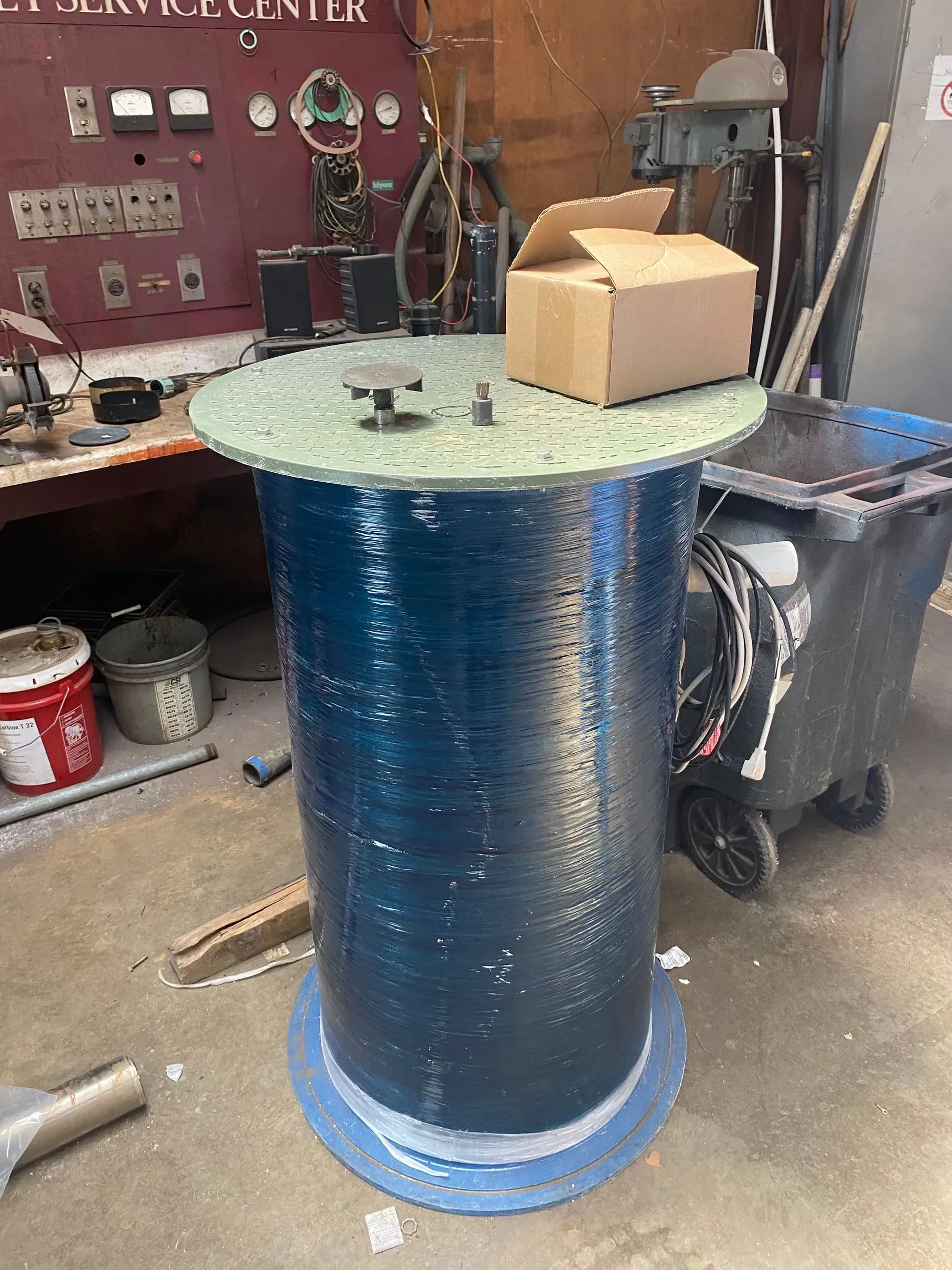 A large house with a garage and a driveway on a rainy day.