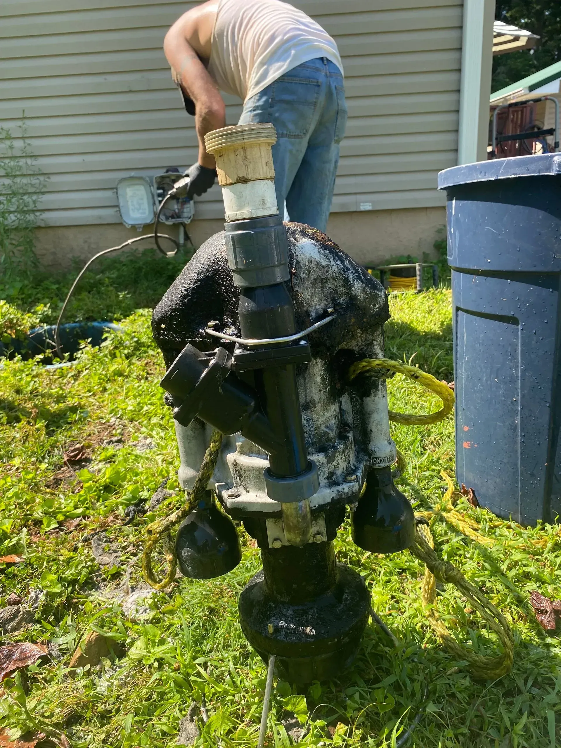 A large house with a lot of windows and a garage on a rainy day.