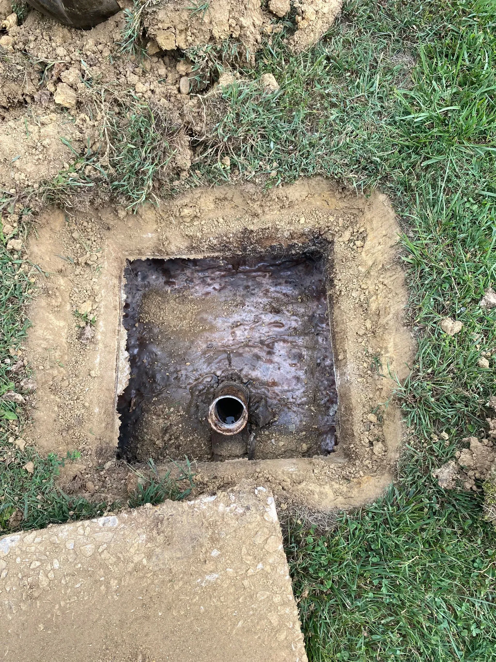 A large house with a lot of windows and a garage on a rainy day.