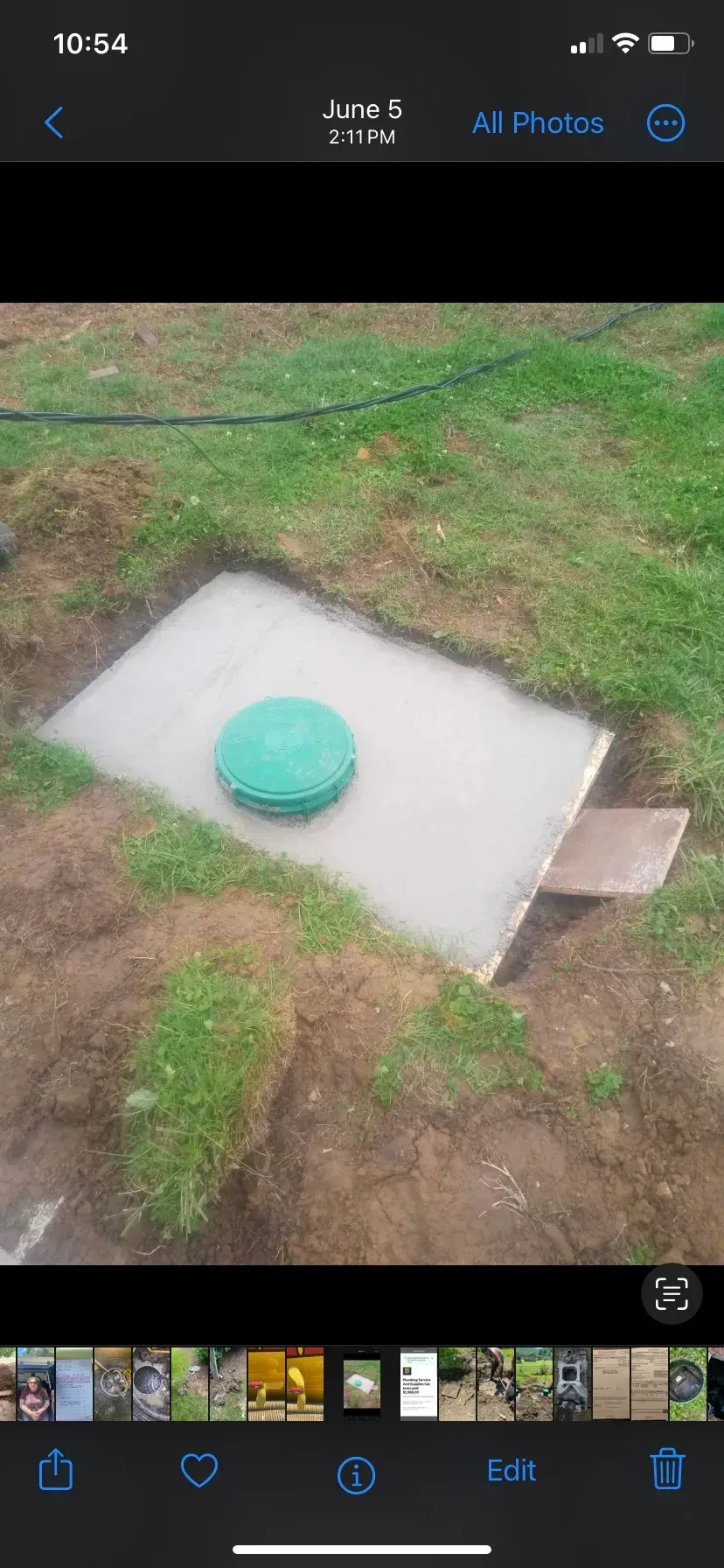 A picture of a septic tank being installed in a yard.