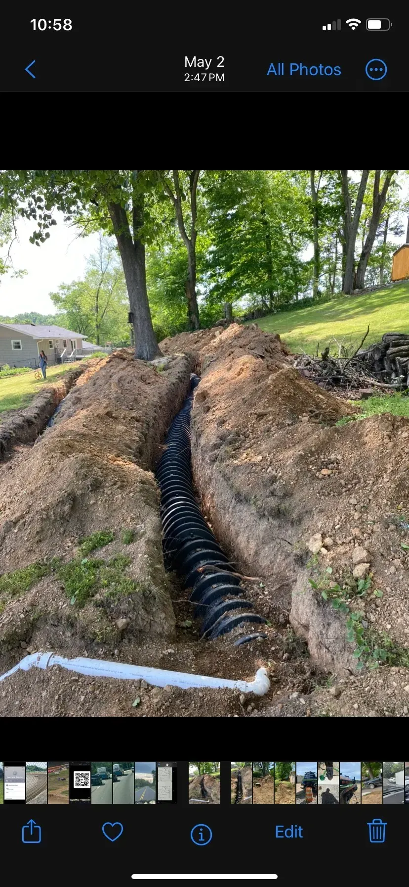 A large house with a lot of windows and a garage on a rainy day.