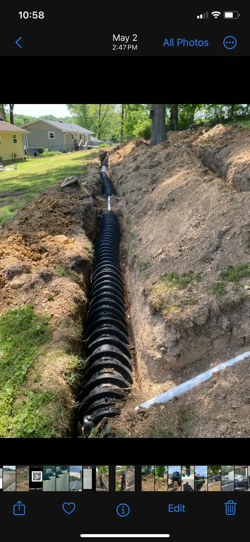 A large house with a lot of windows and a garage on a rainy day.