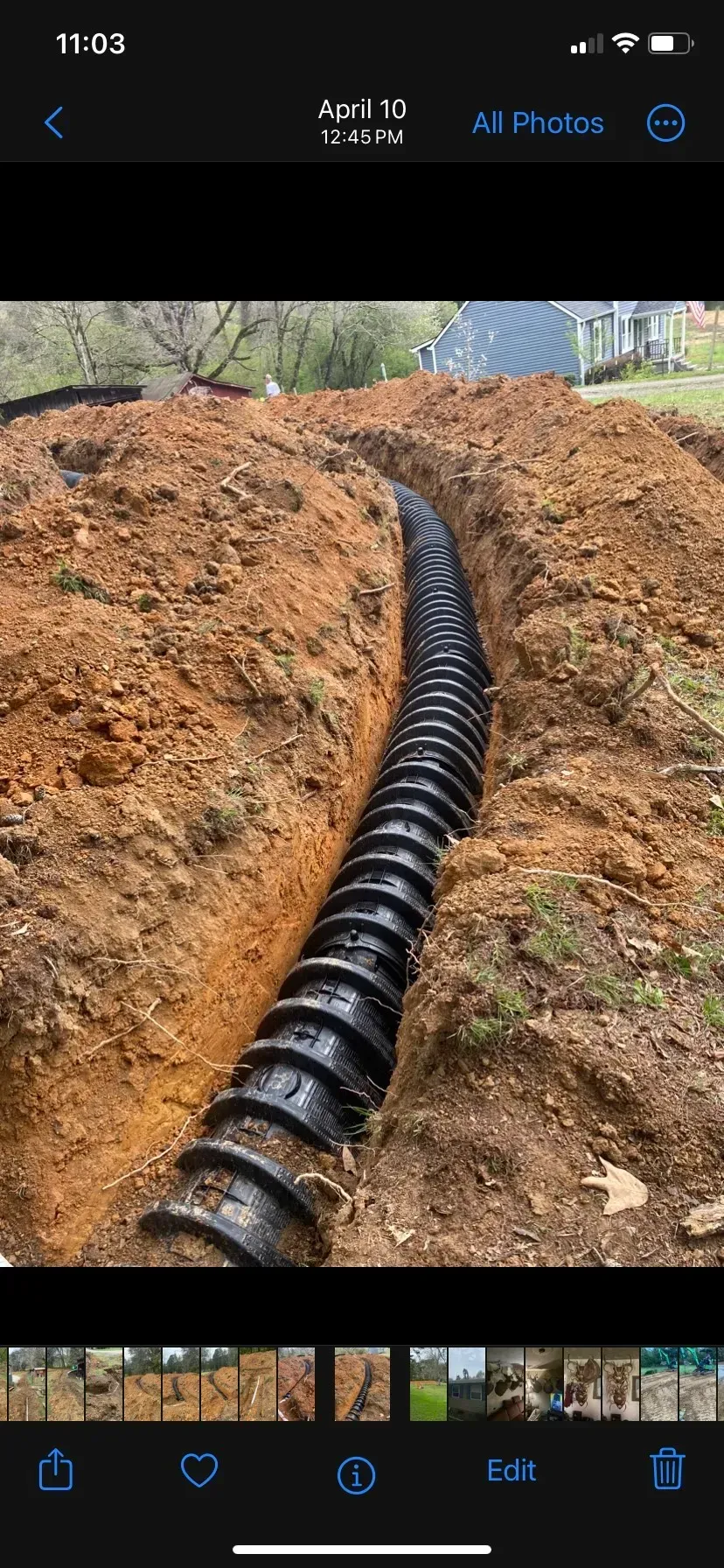 A large house with a lot of windows and a garage on a rainy day.