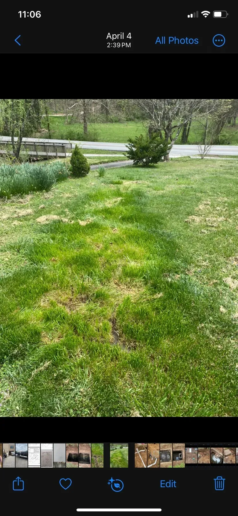 A large house with a lot of windows and a garage on a rainy day.
