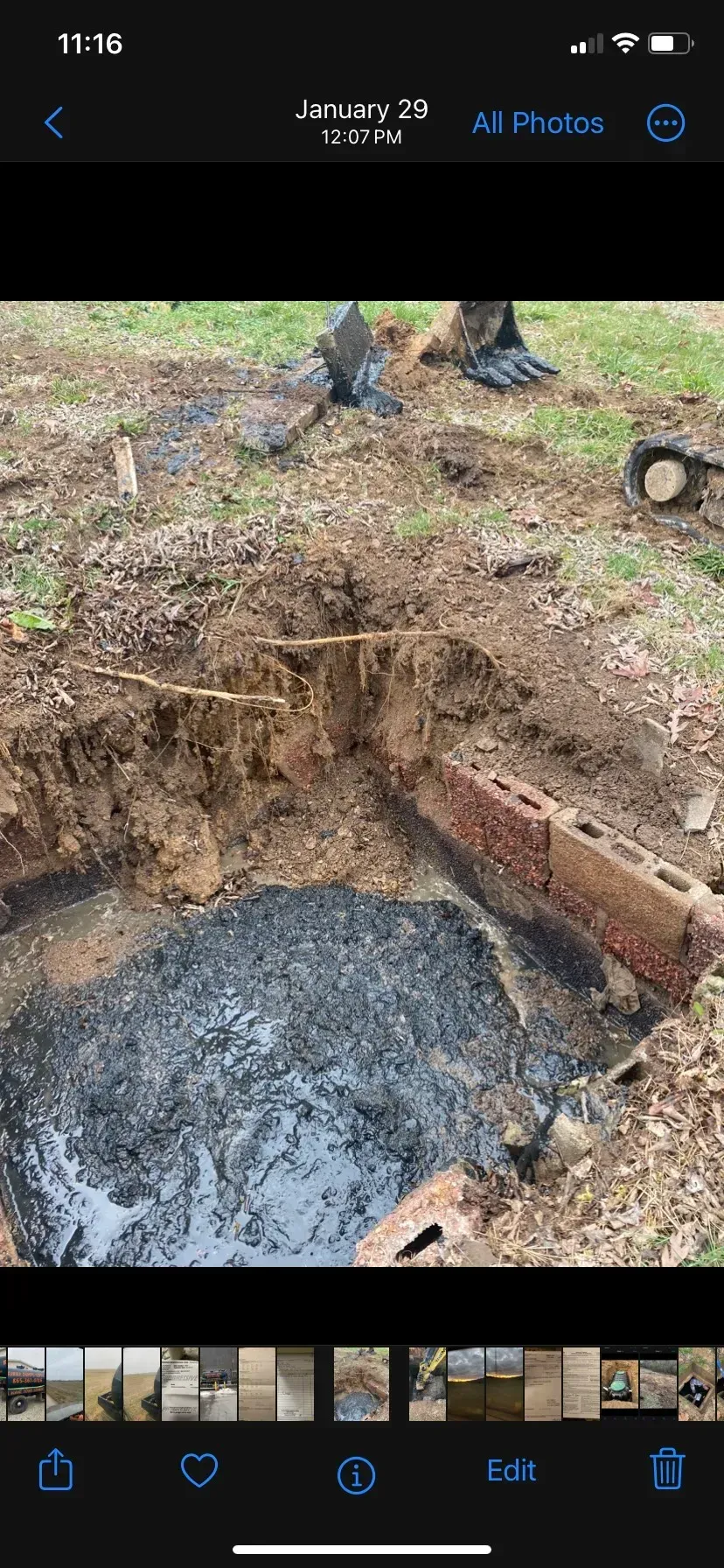 A large house with a lot of windows and a garage on a rainy day.