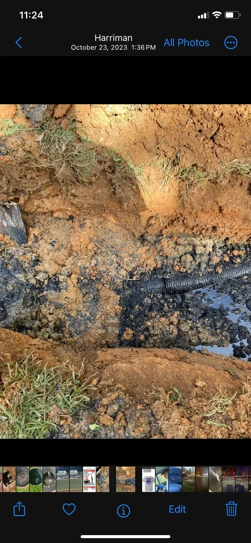 A large house with a lot of windows and a garage on a rainy day.