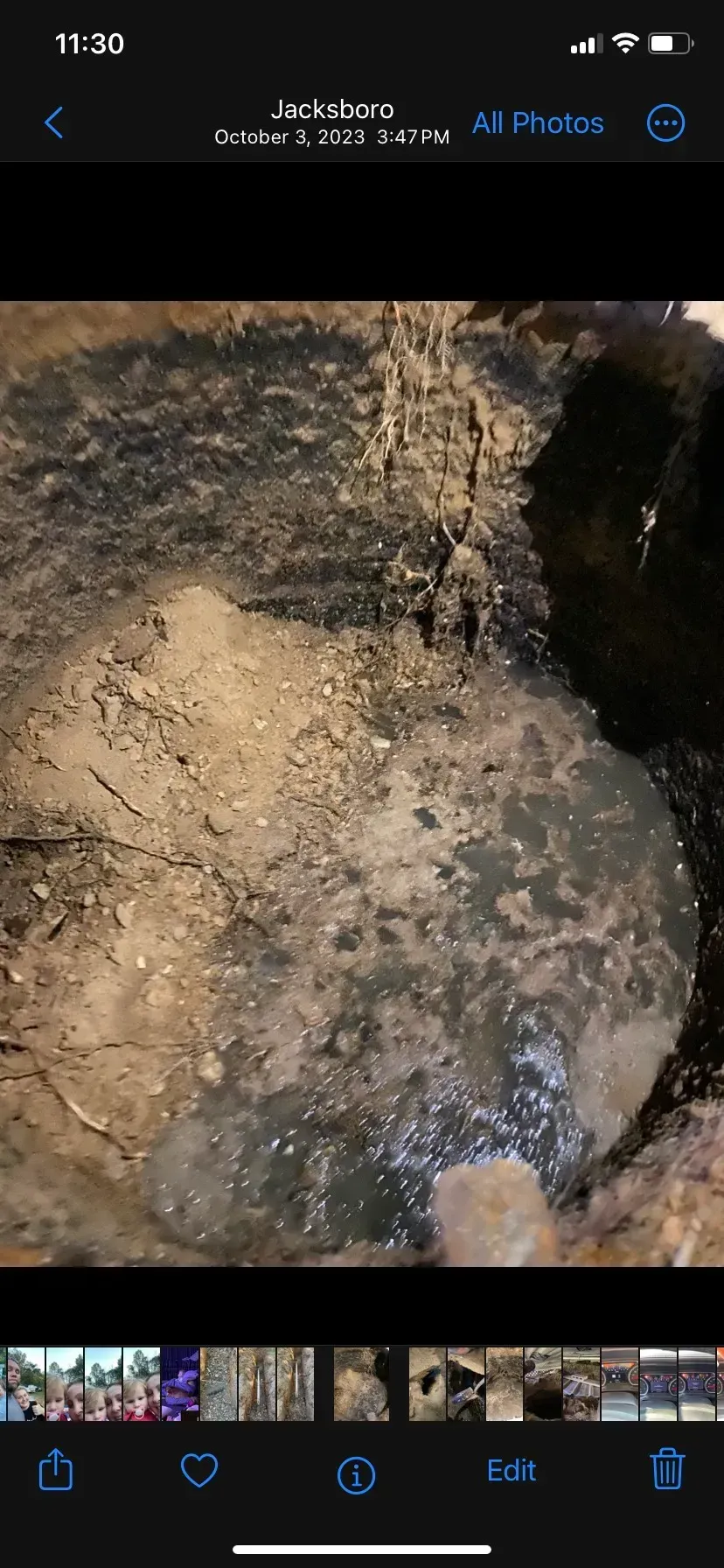 A large house with a lot of windows and a garage on a rainy day.