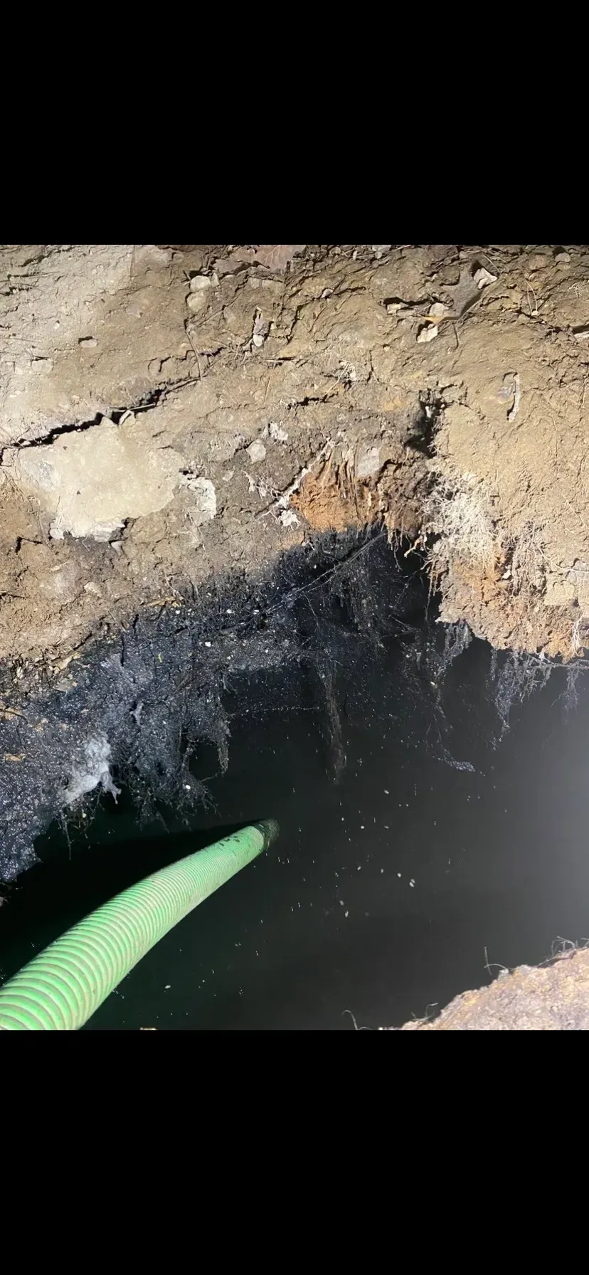 A large house with a lot of windows and a garage on a rainy day.