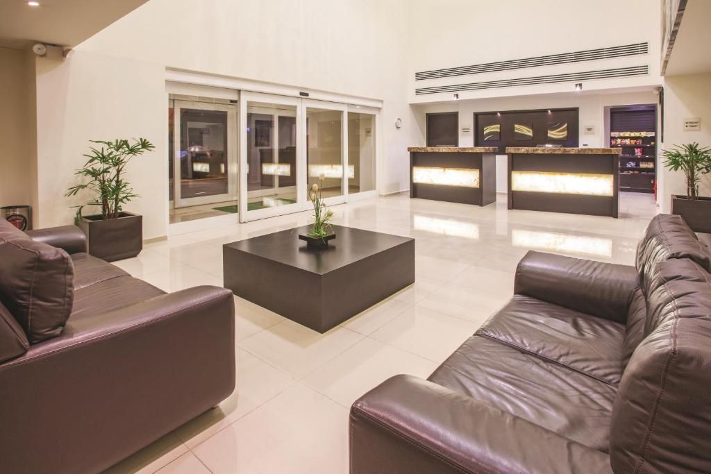 A lobby of a hotel with a couch and a table