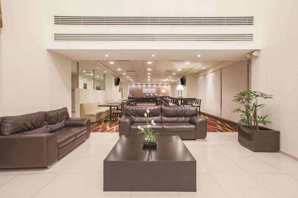 A hotel lobby with a lot of furniture and a table.