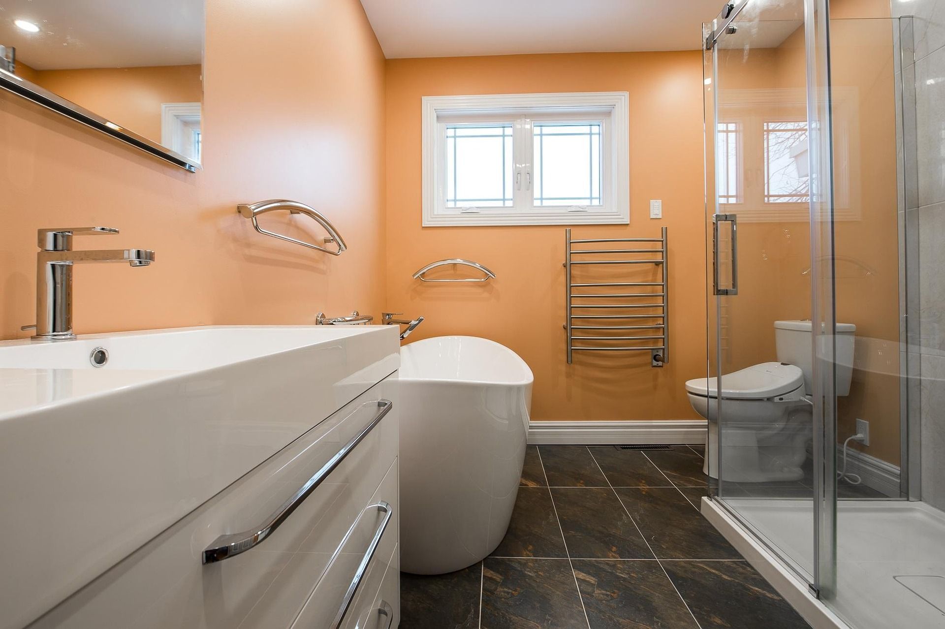 bathroom with orange wall, sink, and a tub