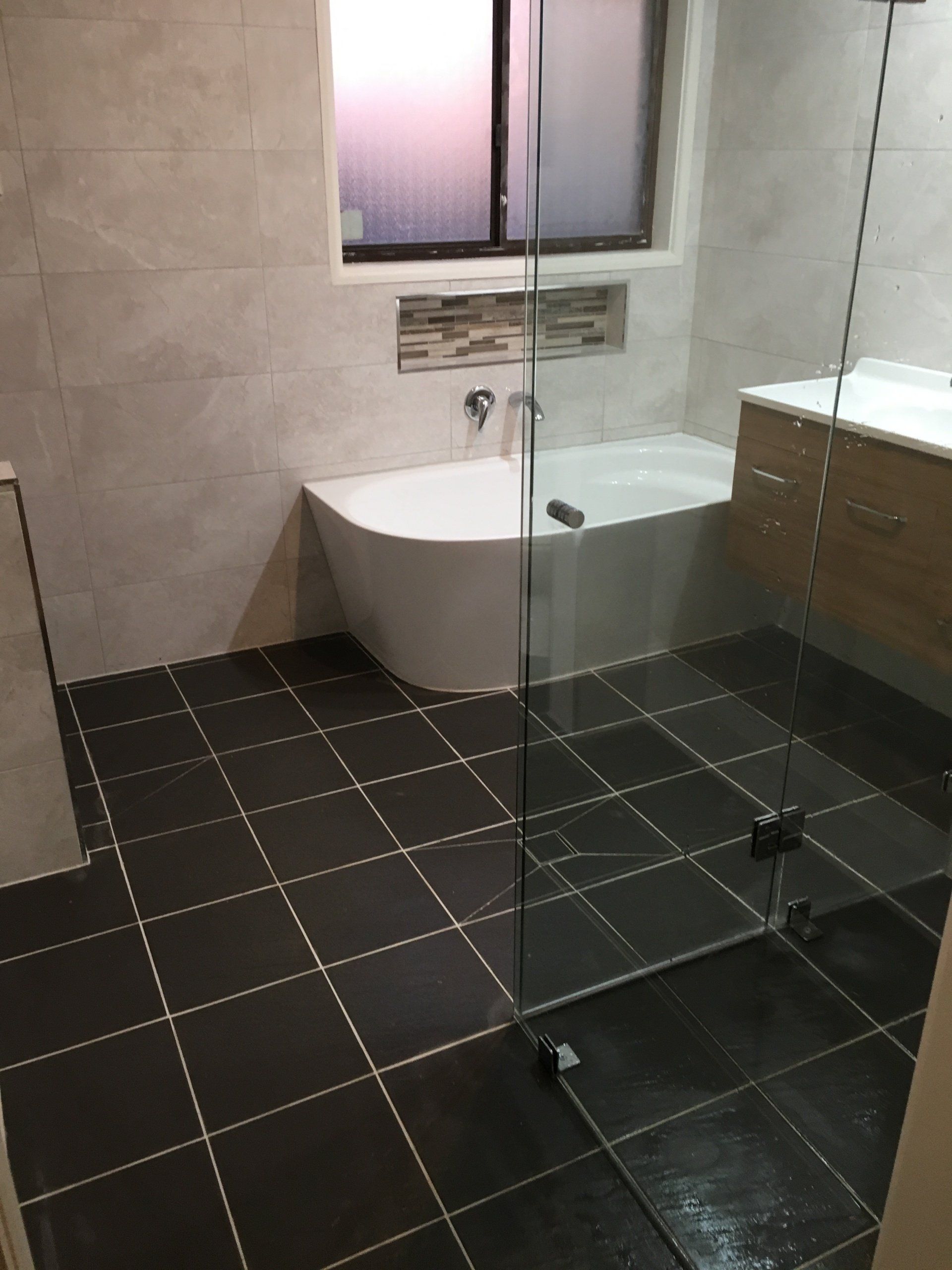 A bathroom with a bathtub and a walk in shower.