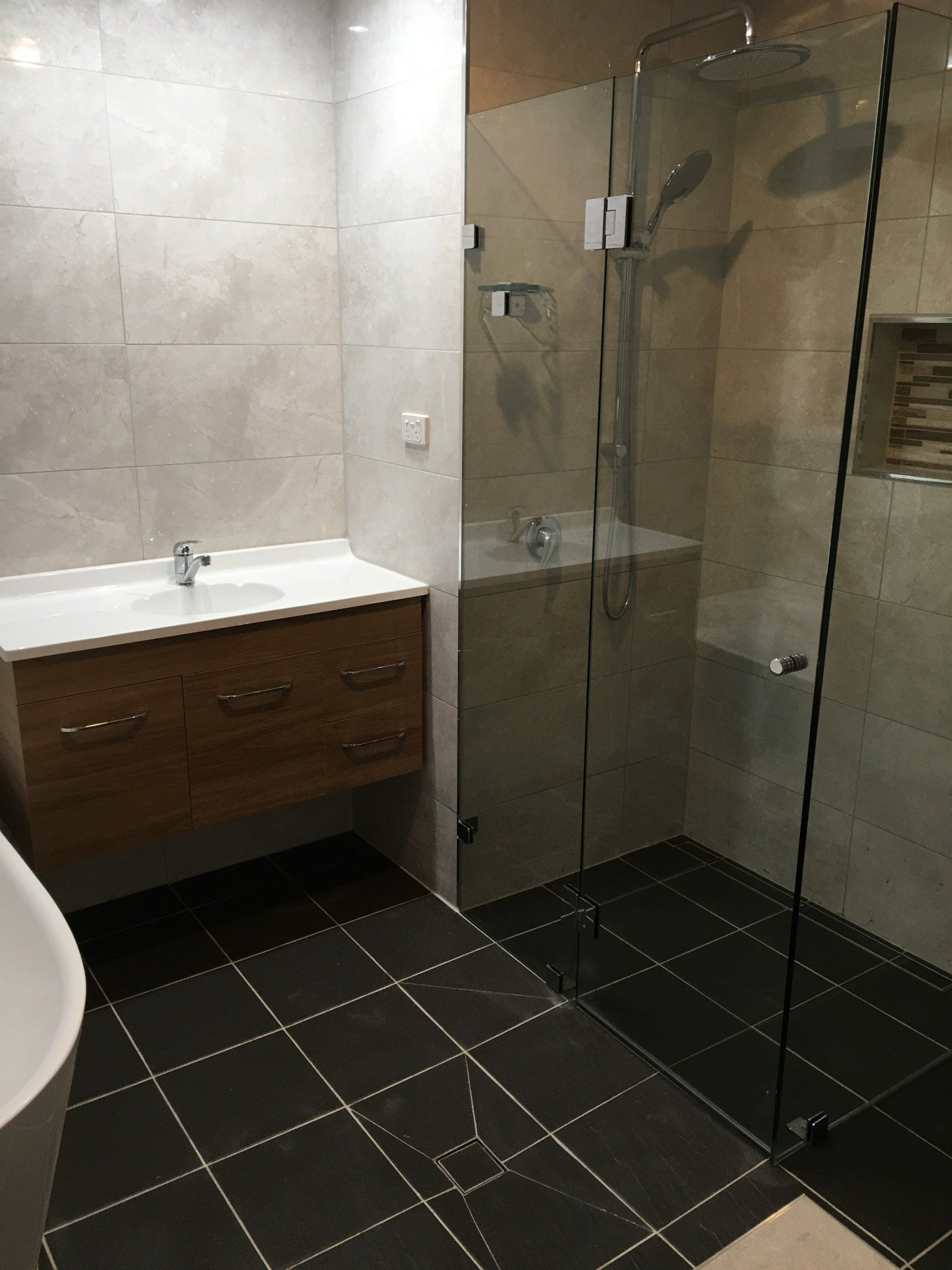 A bathroom with a walk in shower , sink , and bathtub.