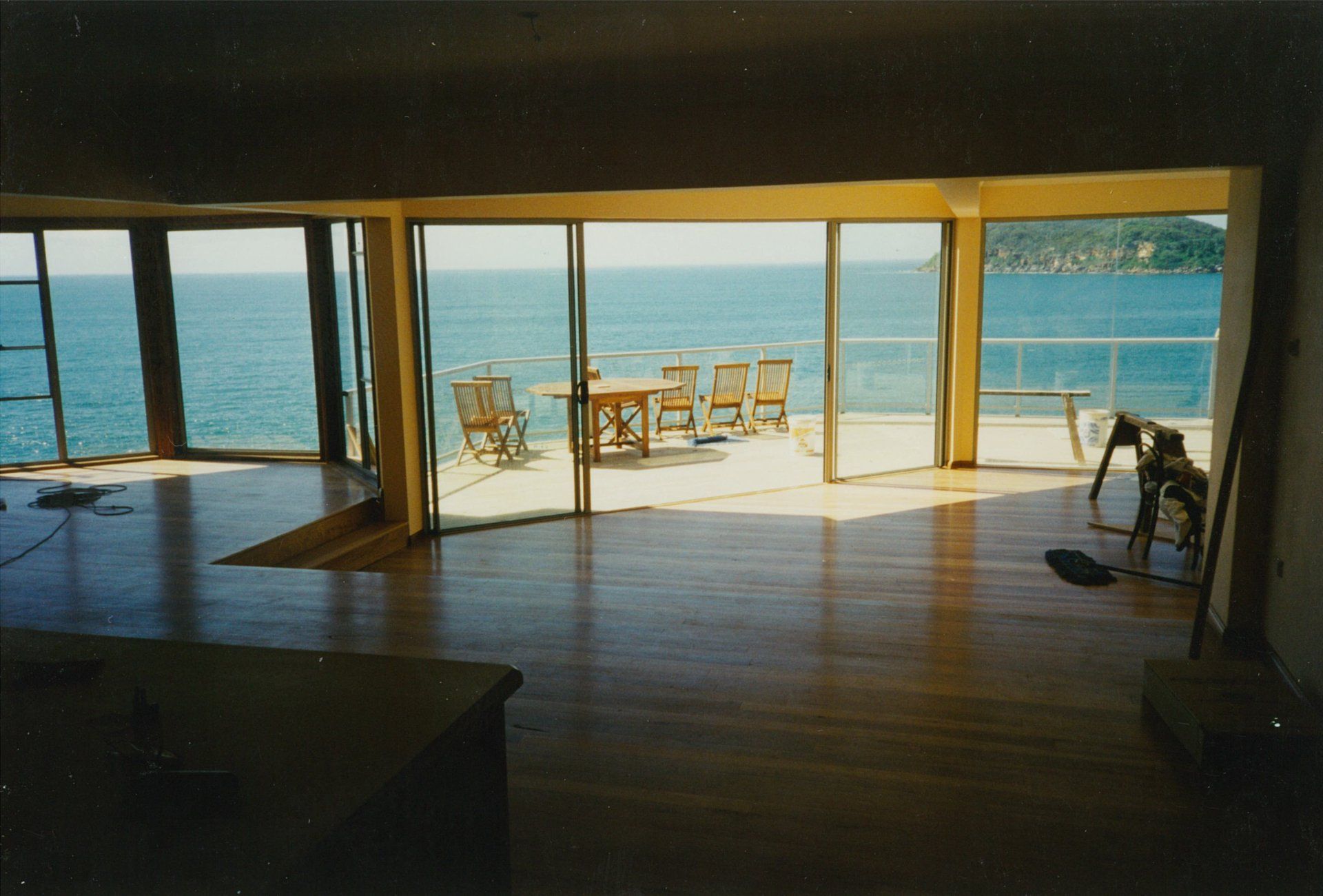 A large room with a view of the ocean