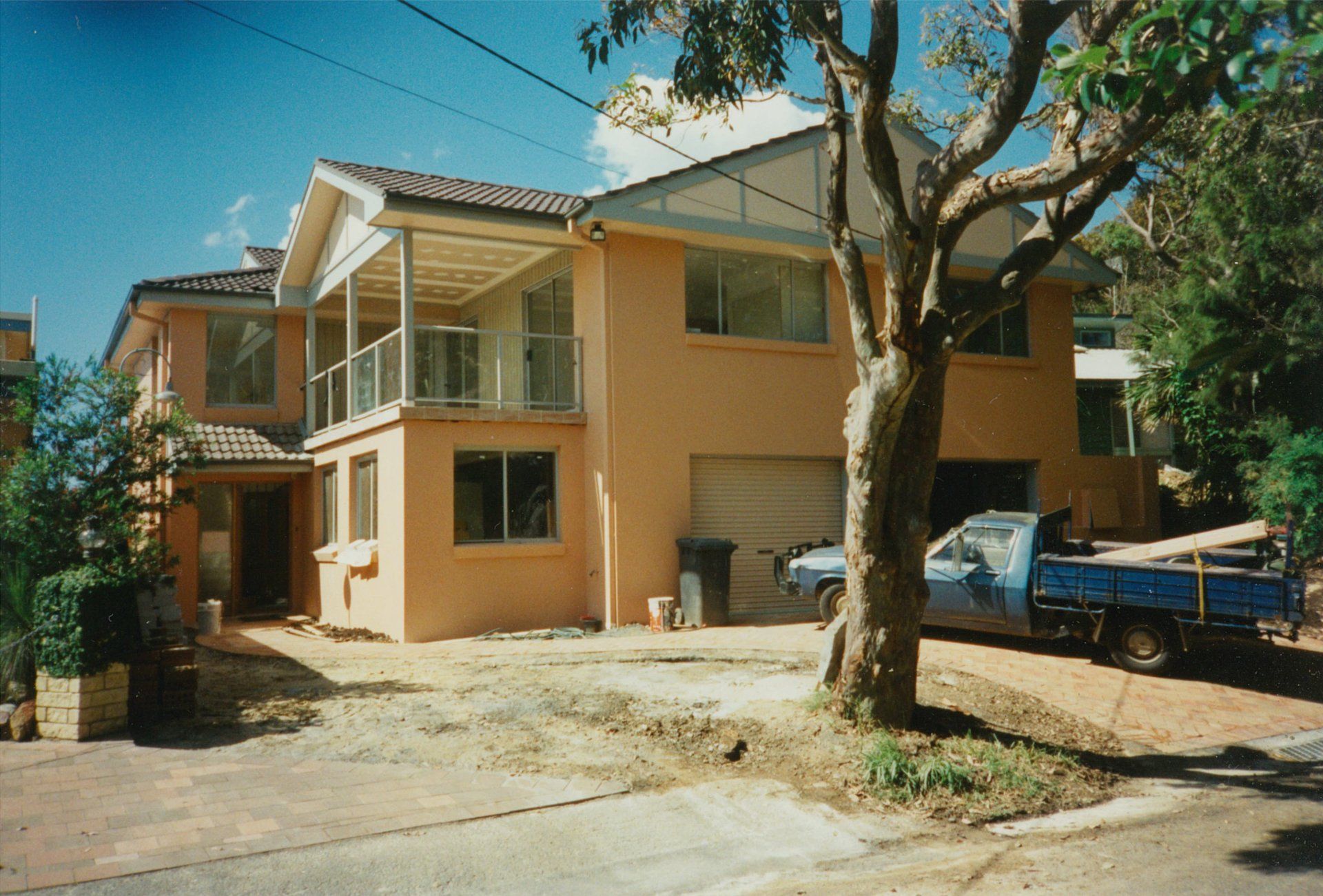 A large house with a blue truck parked in front of it
