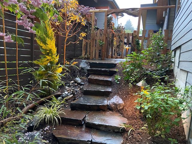 A lush green lawn in front of a house with a purple door.