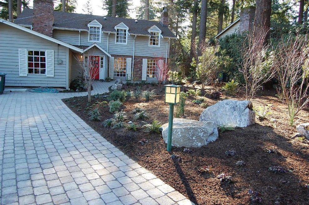 A house with a red door and a brick driveway