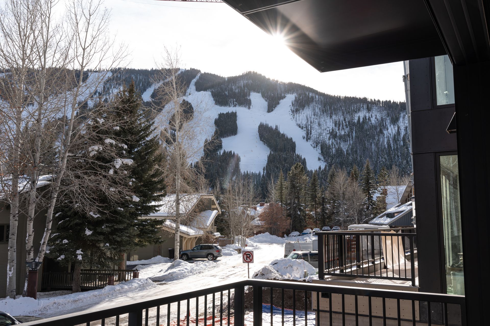View from a balcony of a snowy mountain with the letter 