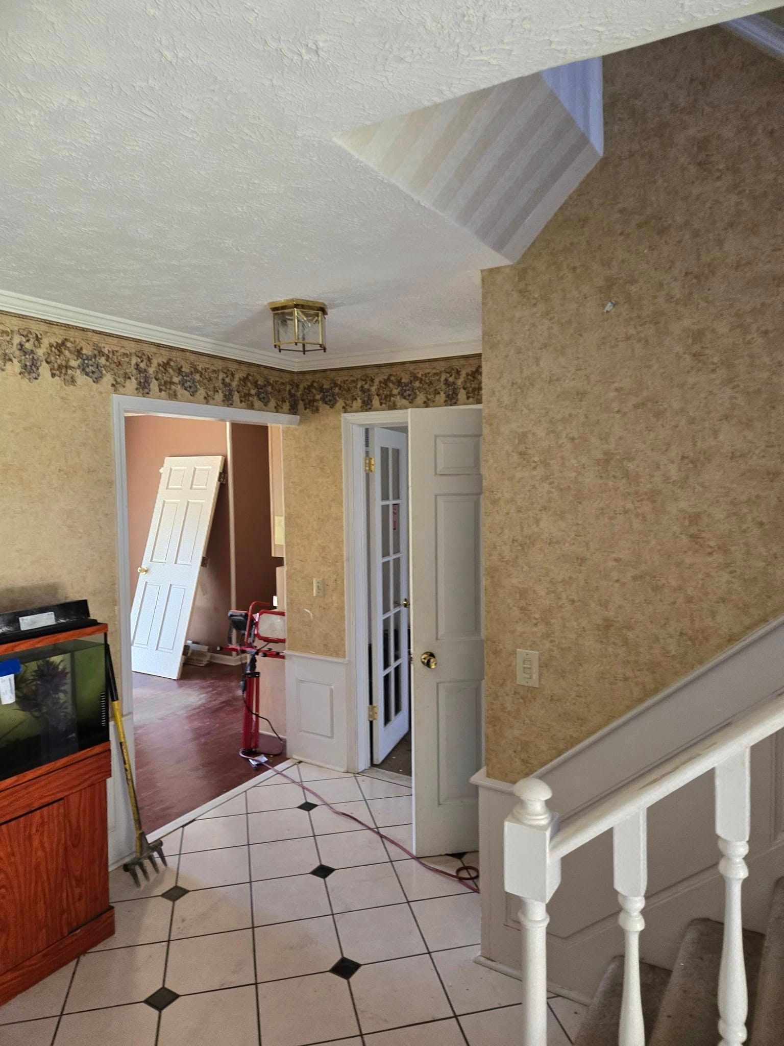 A hallway with stairs leading up to the second floor