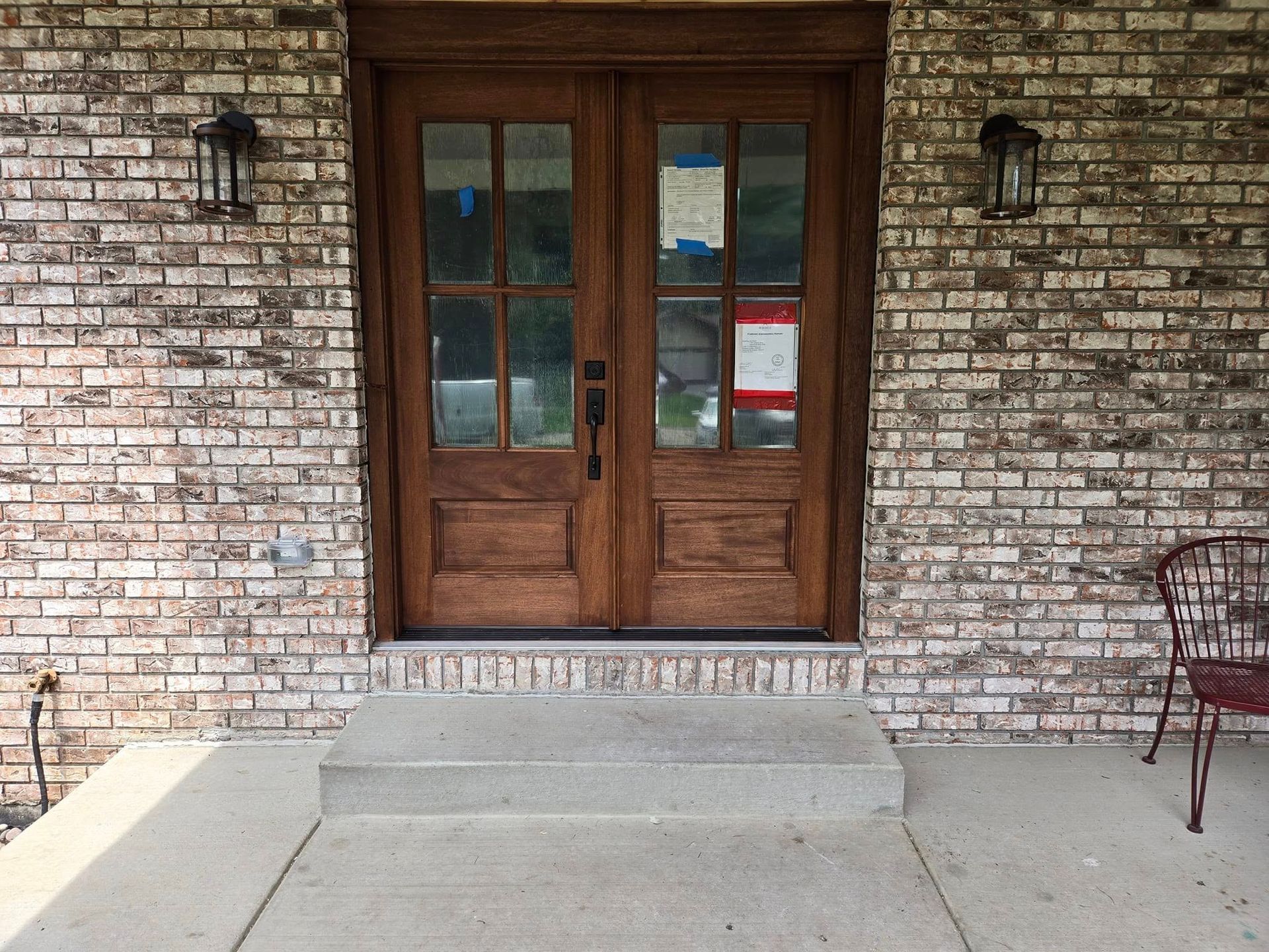 A brick building with a wooden door and steps