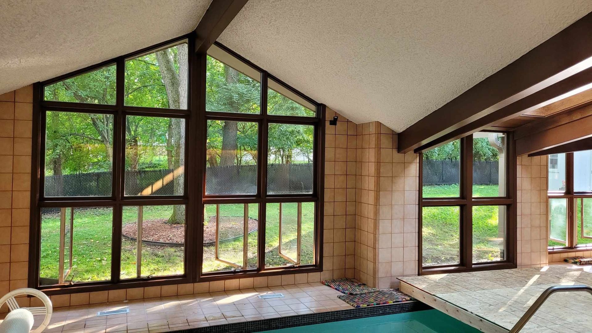 A large indoor swimming pool with a lot of windows