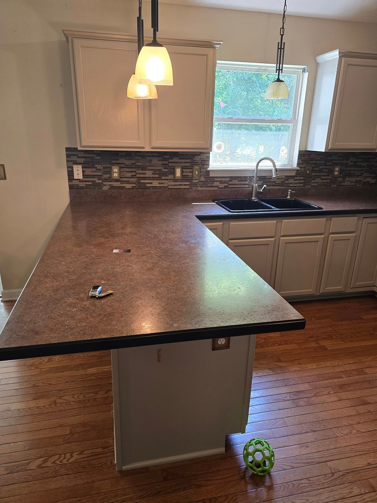 A kitchen with a large island and a sink.