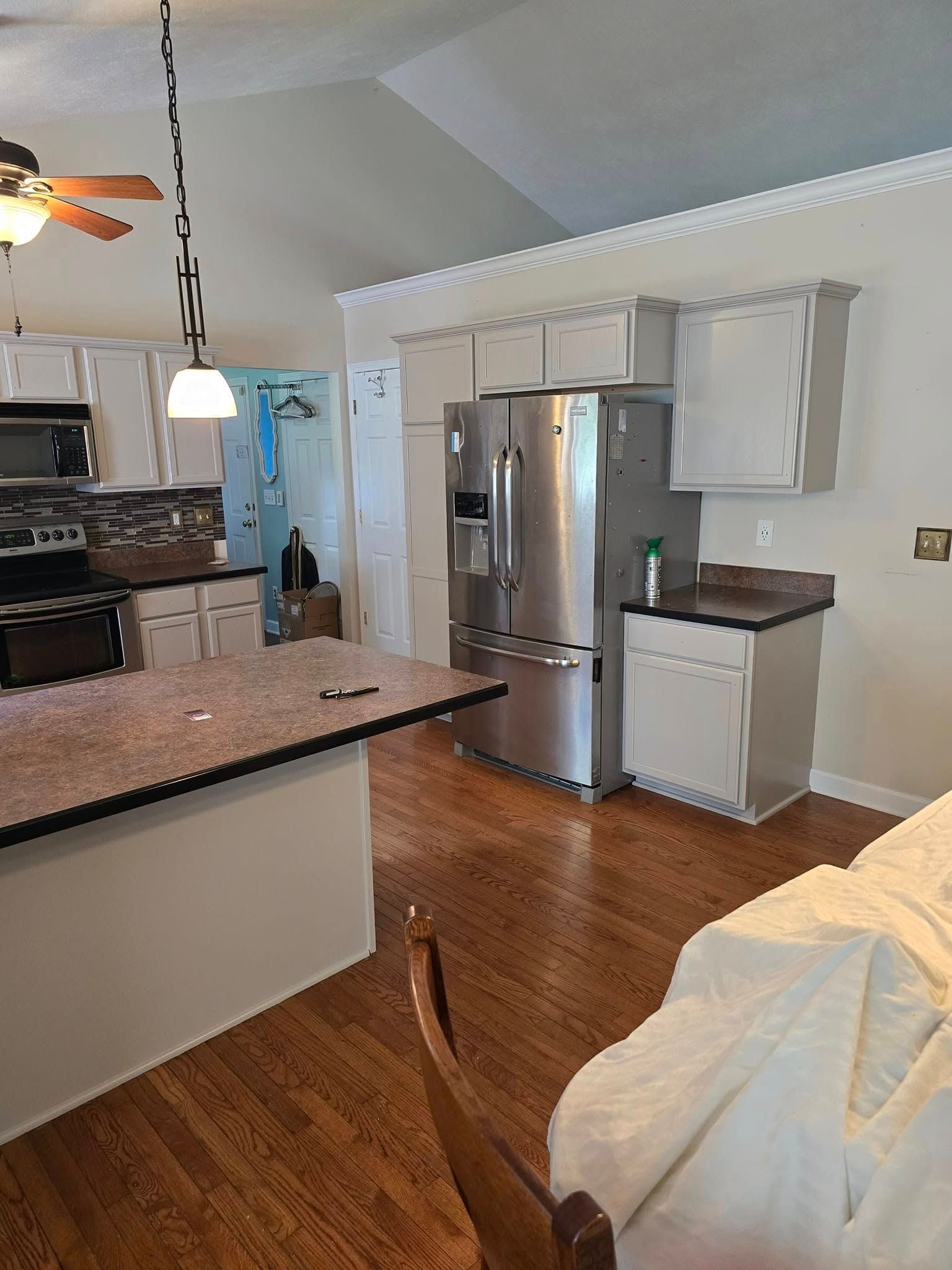 A kitchen with stainless steel appliances and granite counter tops.