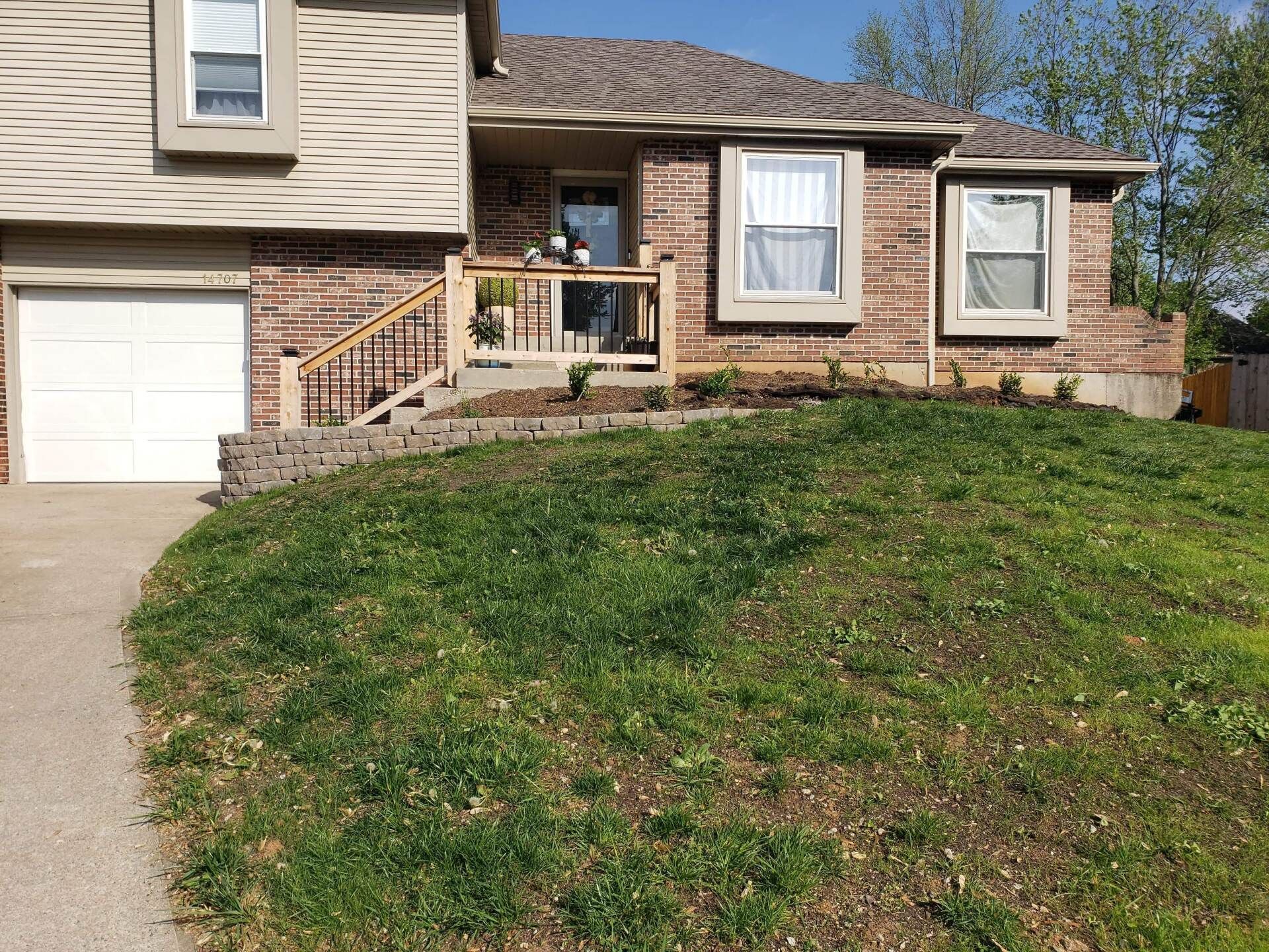 A house with a large lawn in front of it