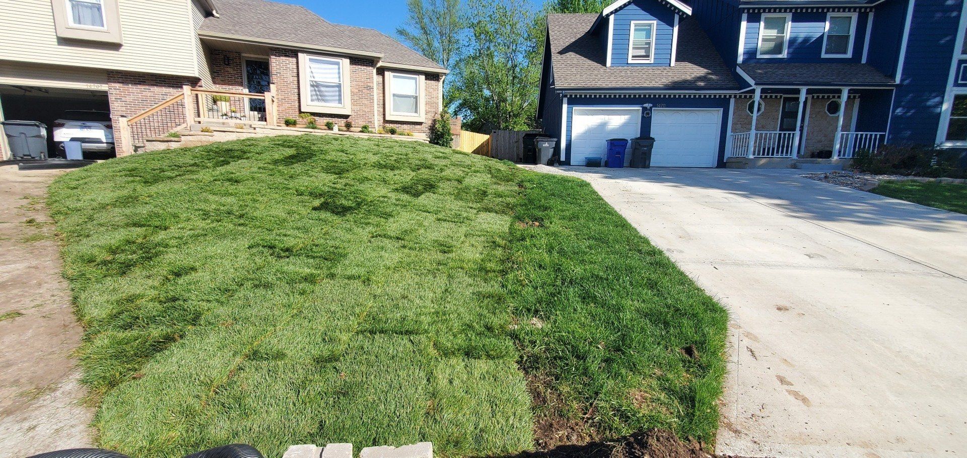 A house with a lot of grass in front of it and a driveway.