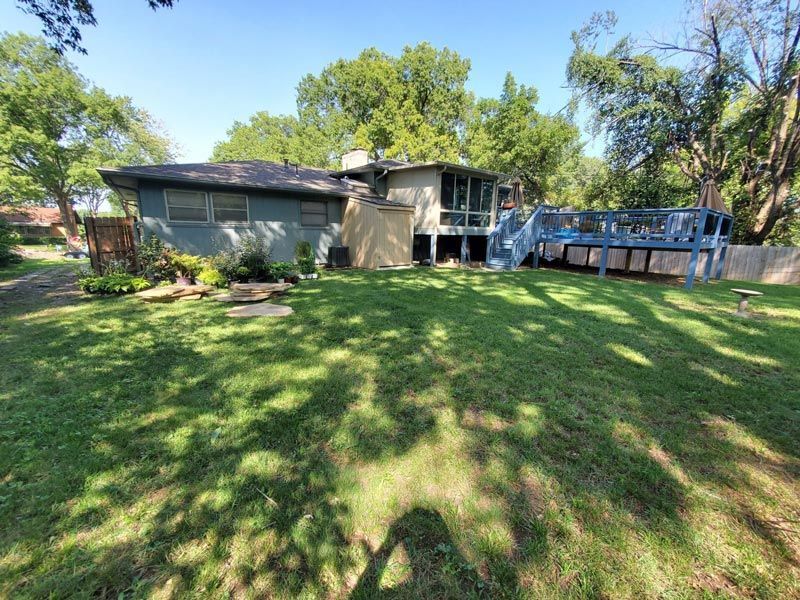 A house with a large lawn in front of it.