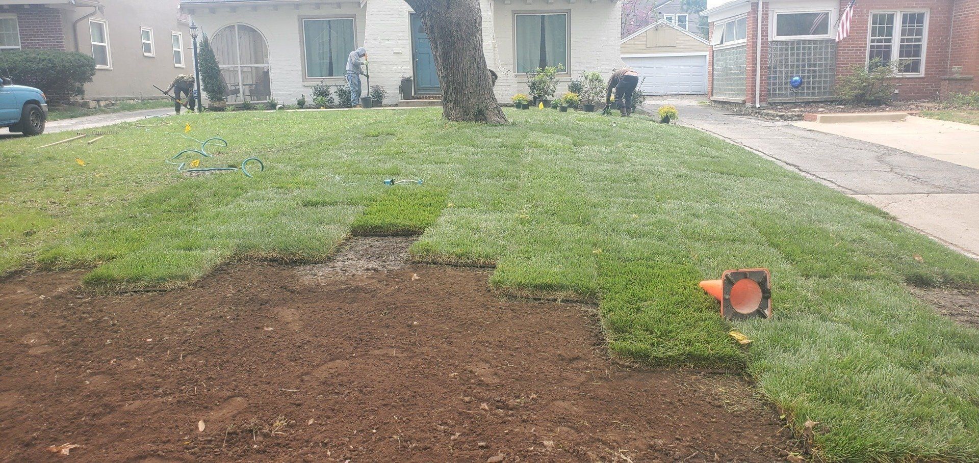 A lawn is being installed in front of a house.