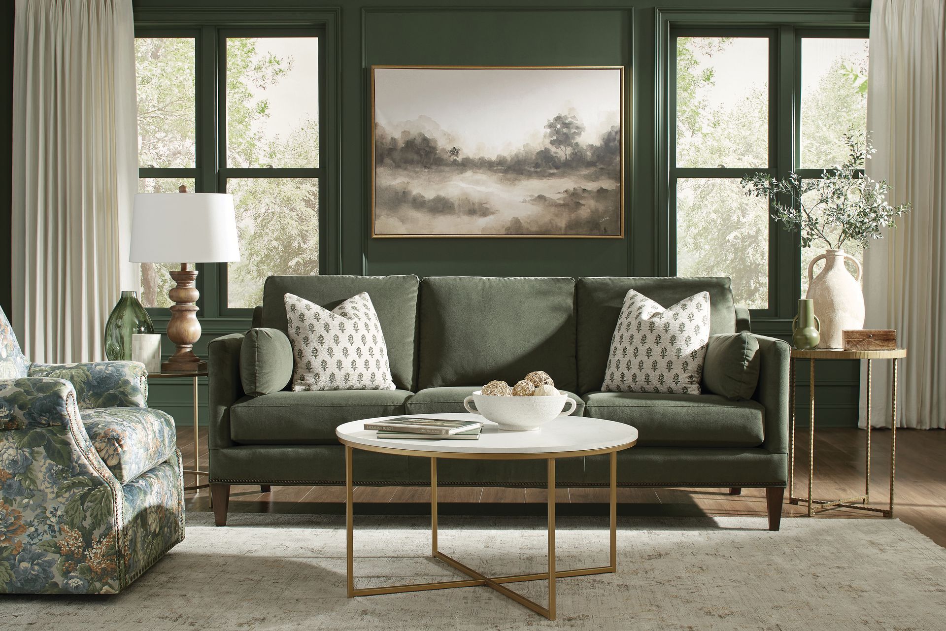 Green living room with sofa, coffee table, and painting.