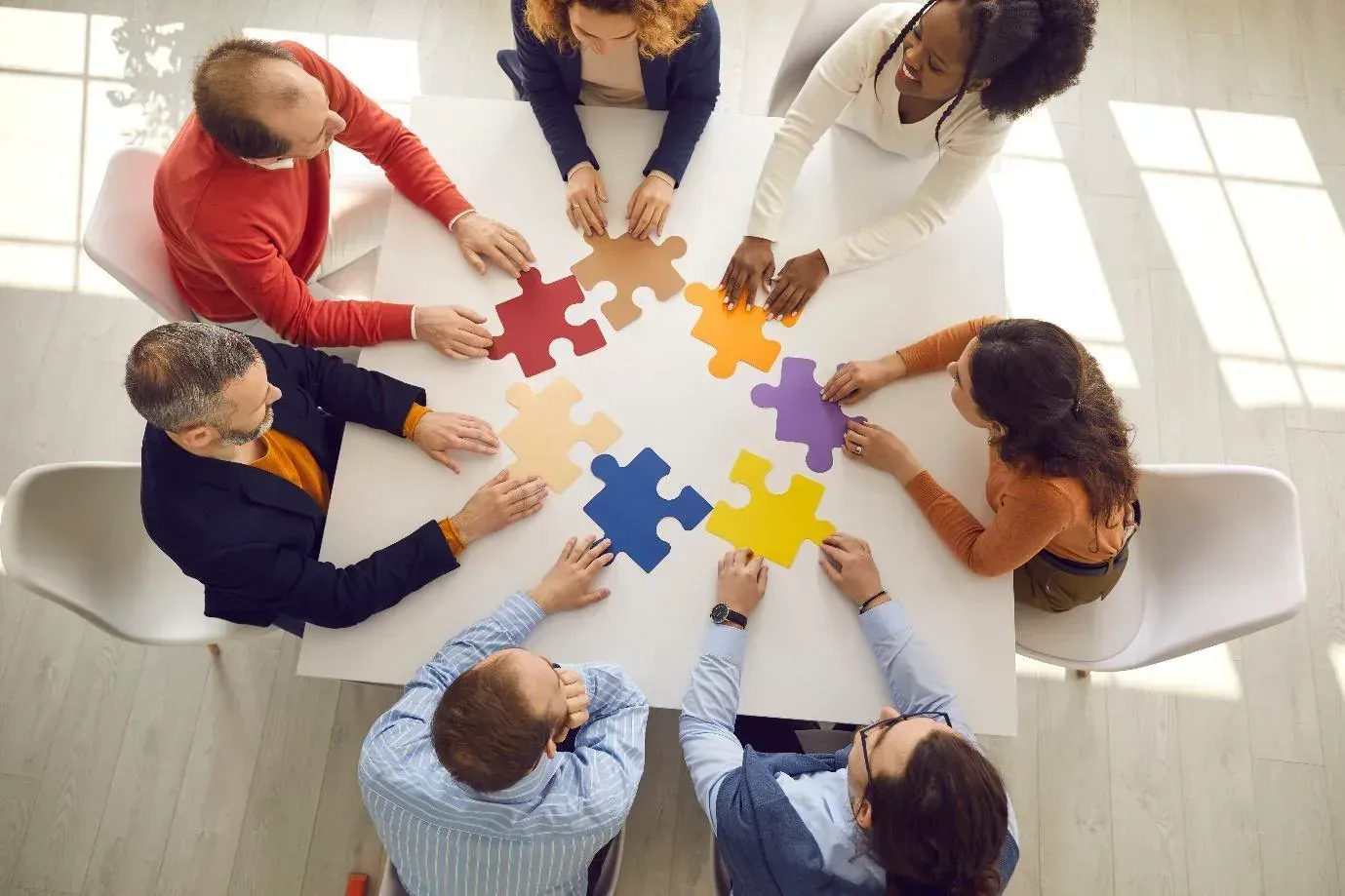 Doctor in white coat with laptop, attending a meeting.