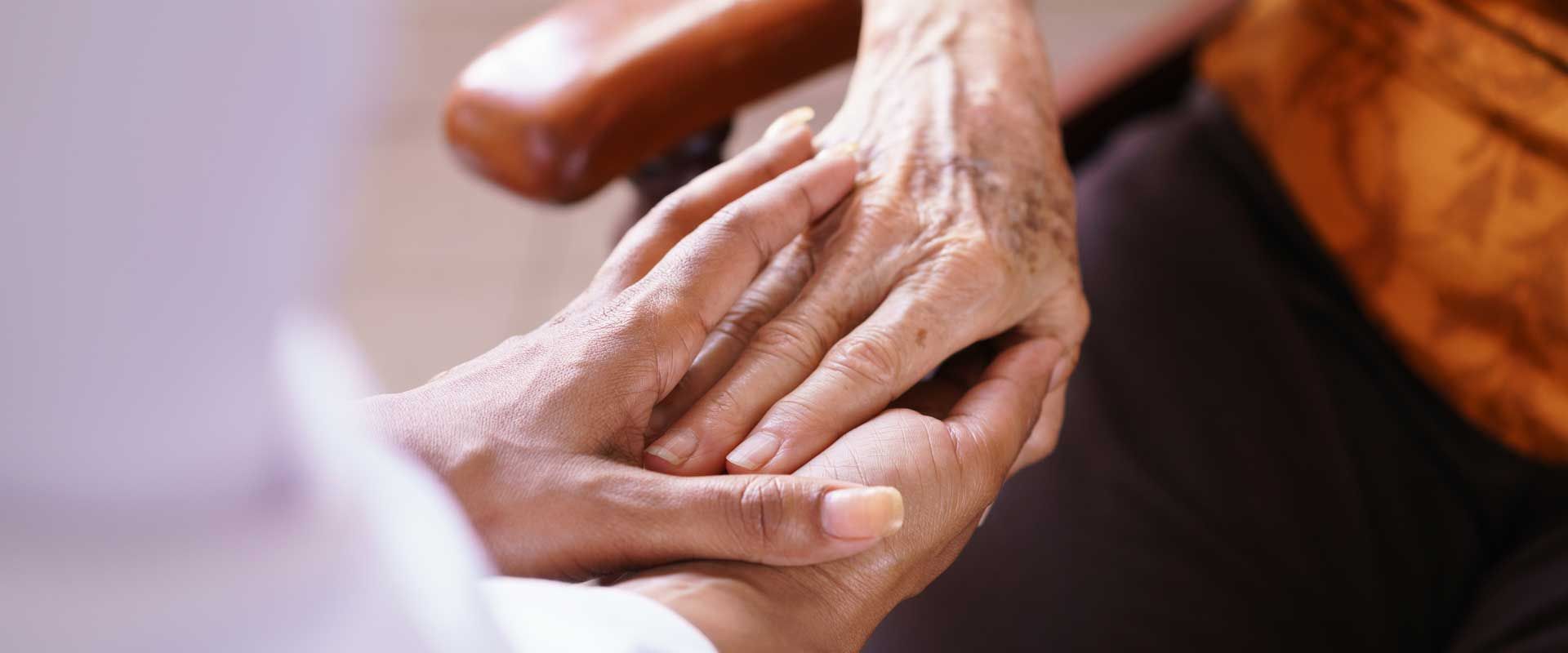 A basket filled with flowers is sitting on a wooden table.